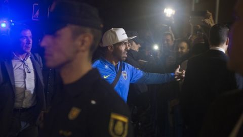 Boca Junior's Carlos Tevez, center, arrives with his team to their hotel in Madrid, Spain, Wednesday, Dec. 5, 2018. The Copa Libertadores Final will be played on Dec. 9 in Spain at Real Madrid's stadium for security reasons after River Plate fans attacked the Boca Junior team bus heading into the Buenos Aires stadium for the meeting of Argentina's fiercest soccer rivals last Saturday. (AP Photo/Paul White)