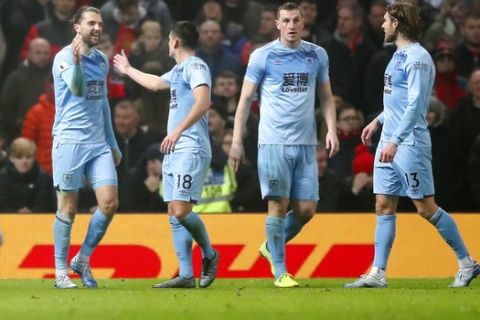 Burnley's Jay Rodriguez, left, celebrates scoring his side's second goal of the game, during the English Premier League soccer match between Manchester United and Burnley, at Old Trafford, in Manchester, England, Wednesday, Jan. 22, 2020. (Martin Rickett/PA via AP)