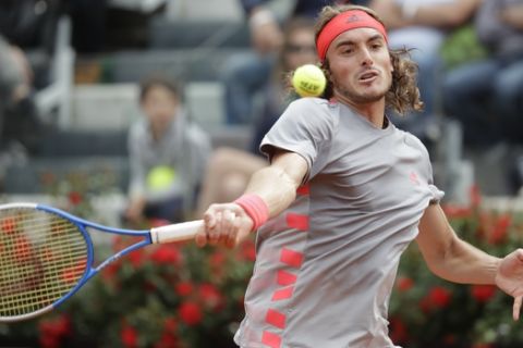 Stefanos Tsitsipas of Greece returns the ball to Rafael Nadal of Spain during a semifinal match at the Italian Open tennis tournament, in Rome, Saturday, May 18, 2019. (AP Photo/Andrew Medichini)
