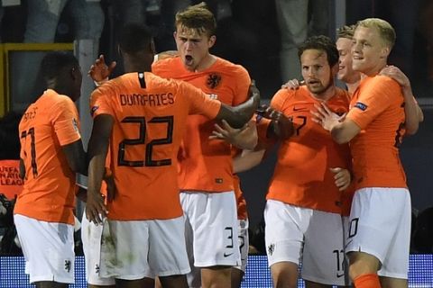 Netherlands' Matthijs de Ligt, center, celebrates with his teammates after scoring his side's opening goal during the UEFA Nations League semifinal soccer match between Netherlands and England at the D. Afonso Henriques stadium in Guimaraes, Portugal, Thursday, June 6, 2019. (AP Photo/Martin Meissner)