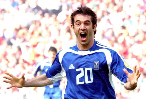 Greece's Georgios Karagounis celebrates after scoring,  during the Euro 2004 Group A soccer match between Portugal and Greece, at the Dragao stadium in Porto, Portugal, Saturday, June 12, 2004. The other teams in Group A are Russia and Spain. (AP Photo/Luca Bruno)