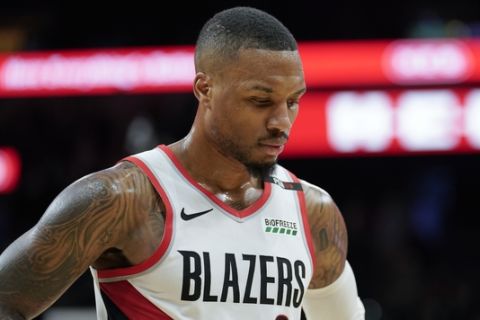 Portland Trail Blazers' Damian Lillard walks to the bench during the second half of an NBA basketball game against the San Antonio Spurs, Sunday, Dec. 2, 2018, in San Antonio. San Antonio won 131-118. (AP Photo/Darren Abate)