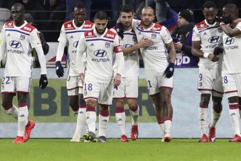 Lyon players celebrate scoring their side's first goal during the French League One soccer match between Lyon and Paris Saint-Germain in Decines, near Lyon, central France, Sunday, Feb. 3, 2019. (AP Photo/Laurent Cipriani)