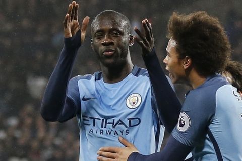 Manchester City's Yaya Toure, left, celebrates scoring a goal with Manchester City's Leroy Sane during the English Premier League soccer match between West Ham and Manchester City at the London stadium, Wednesday, Feb. 1, 2017. (AP Photo/Frank Augstein)