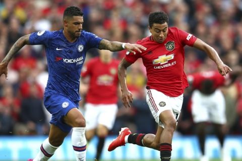 Chelsea's Emerson Palmieri, left, vies for the ball with Manchester United's Jesse Lindgard during the English Premier League soccer match between Manchester United and Chelsea at Old Trafford in Manchester, England, Sunday, Aug. 11, 2019. (AP Photo/Dave Thompson)