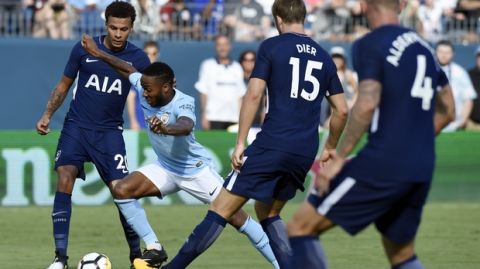 Manchester City forward Raheem Sterling, second from left, dribbles the ball between Tottenham's Dele Alli (20) and Eric Dier (15) during the first half of an International Champions Cup soccer match Saturday, July 29, 2017, in Nashville, Tenn. (AP Photo/Mark Zaleski)