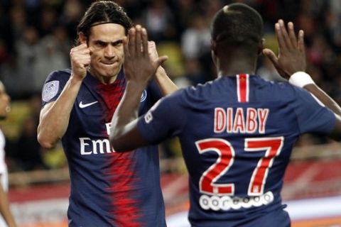 PSG's Edinson Cavani, left, celebrates with teammate Moussa Diaby after scoring his third goal of the game, during the French League One soccer match between AS Monaco and Paris Saint-Germain at Stade Louis II in Monaco, Sunday, Nov. 11, 2018 (AP Photo/Claude Paris)