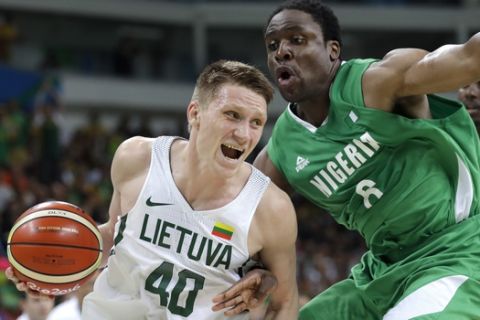 Lithuania's Marius Grigonis (40) drives around Nigeria's Ike Diogu (6) during a men's basketball game at the 2016 Summer Olympics in Rio de Janeiro, Brazil, Tuesday, Aug. 9, 2016. (AP Photo/Eric Gay)