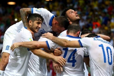 FORTALEZA, BRAZIL - JUNE 24: Andreas Samaris of Greece (obscured) celebrates scoring his team's first goal with teammates during the 2014 FIFA World Cup Brazil Group C match between Greece and Cote D'Ivoire at Estadio Castelao on June 24, 2014 in Fortaleza, Brazil.  (Photo by Alex Livesey - FIFA/FIFA via Getty Images)