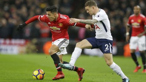 Manchester United's Alexis Sanchez, left, and Tottenham's Kieran Trippier, right, vie for the ball during the English Premier League soccer match between Tottenham Hotspur and Manchester United at Wembley stadium, in London, Wednesday Jan. 31, 2018. (AP Photo/Alastair Grant)