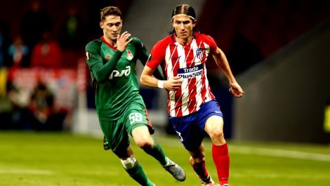 Atletico Madrid's Filipe Luis, right, is challenged by Lokomotiv's Aleksei Miranchuk during the Europa League Round of 16 first leg soccer match between Atletico Madrid and Lokomotiv Moscow at the Metropolitano stadium in Madrid, Thursday, March 8, 2018. (AP Photo/Francisco Seco)