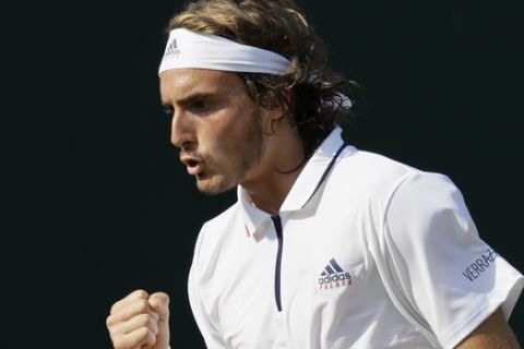 Stefanos Tsitsipas of Greece celebrates winning a point from Thomas Fabbiano of Italy during their men's singles match on the fifth day at the Wimbledon Tennis Championships in London, Friday July 6, 2018. (AP Photo/Kirsty Wigglesworth)