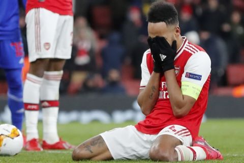 Arsenal's Pierre-Emerick Aubameyang reacts after losing the Europa League round of 32, second leg, soccer match between Arsenal and Olympiakos at Emirates stadium in London, England, Thursday, Feb. 27, 2020 . (AP Photo/Frank Augstein)