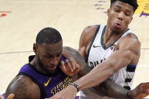 Milwaukee Bucks forward Giannis Antetokounmpo, right, knocks the ball from the hands of Los Angeles Lakers forward LeBron James during the second half of an NBA basketball game Friday, March 1, 2019, in Los Angeles. The Bucks won 131-120. (AP Photo/Mark J. Terrill)