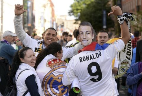 A Real Madrid fan wearing a Cristiano Ronaldo mask gestures, ahead of the Champions League final match between Juventus and Real Madrid in Cardiff, Wales, Saturday June 3, 2017. Joe Giddens/PA via AP)