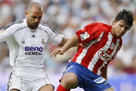 Real Madrid Raul Bravo, left, player duels for the ball with Atletico de Madrid Sergio Aguero player during their Spanish league soccer match at the Santiago Bernabeu Stadium in Madrid, Sunday, Oct. 1, 2006. (AP Photo/Jasper Juinen)