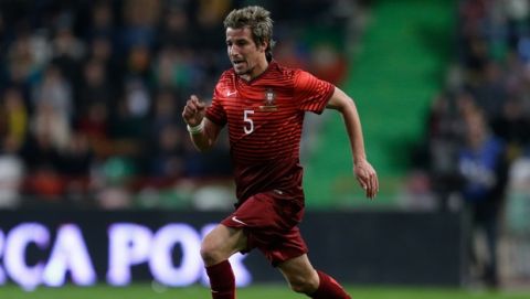Portugal's Fabio Coentrao runs with the ball during their friendly soccer match with Cameroon Wednesday, March 5 2014, in Leiria, Portugal. (AP Photo/Armando Franca)