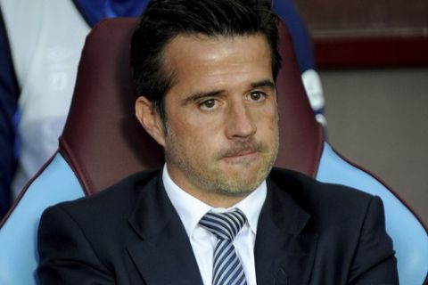 Everton's manager Marco Silva looks out from the bench prior the English Premier League soccer match between Aston Villa and Everton at Villa Park in Birmingham, England, Friday, Aug. 23, 2019. (AP Photo/Rui Vieira)