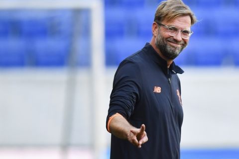 Liverpool's coach Juergen Klopp gestures during the training session in preparation for upcoming Champions League's qualifier soccer match between 1899 Hoffenheim and FC Liverpool,  in the Rhein-Neckar-Arena in Sinsheim, Germany, Monday Aug. 14, 2017.  (Uwe Anspach/dpa via AP)