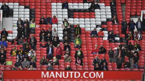 Manchester United fans inside the stadium before the English Premier League soccer match between Manchester United and Fulham at Old Trafford stadium in Manchester, England, Tuesday, May 18, 2021. (AP Photo/Paul Ellis, Pool)