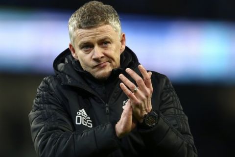 Manchester United's manager Ole Gunnar Solskjaer applauds the supporters at the end of the English League Cup semifinal second leg soccer match between Manchester City and Manchester United at Etihad stadium in Manchester, England, Wednesday, Jan. 29, 2020. Manchester United won the game 1-0 bu Manchester City advances on a 3-2 aggregate score. (AP Photo/Dave Thompson)