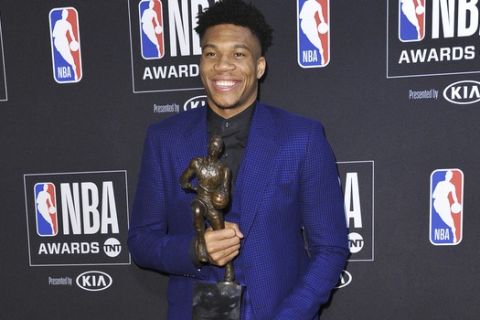 NBA player Giannis Antetokounmpo, of the Milwaukee Bucks, poses in the press room with most valuable player award at the NBA Awards on Monday, June 24, 2019, at the Barker Hangar in Santa Monica, Calif. (Photo by Richard Shotwell/Invision/AP)