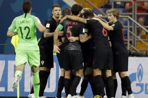 Croatia players celebrate after their teammate Ivan Perisic scored his side's second goal during the group D match between Iceland and Croatia, at the 2018 soccer World Cup in the Rostov Arena in Rostov-on-Don, Russia, Tuesday, June 26, 2018. (AP Photo/Natacha Pisarenko)