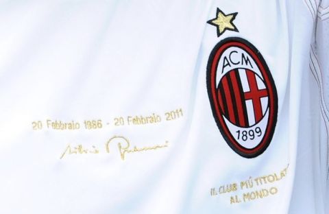AC Milan's Alessandro Nesta arrives on a field wearing a soccer jersey with a sign of President Silvio Berlusconi to celebrate his 25th anniversary as president during a soccer match against Chievo Verona at the Bentegodi stadium in Verona February 20, 2011.  REUTERS/ Image Sport  (ITALY - Tags: SPORT SOCCER)