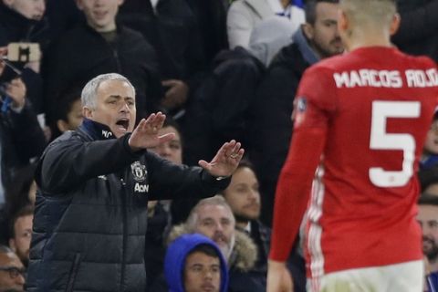 Manchester United's manager Jose Mourinho, left, gestures as Manchester United's Marcos Rojo watches during the English FA Cup quarterfinal soccer match between Chelsea and Manchester United at Stamford Bridge stadium in London, Monday, March 13, 2017 (AP Photo/Alastair Grant)