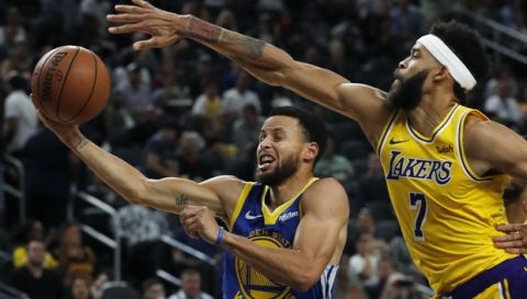 Golden State Warriors guard Stephen Curry shoots around Los Angeles Lakers center JaVale McGee during the second half of an NBA preseason basketball game Wednesday, Oct. 10, 2018, in Las Vegas. (AP Photo/John Locher)