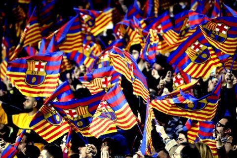Barcelona fans wave flags prior to the Copa del Rey semifinal first leg soccer match between FC Barcelona and Real Madrid at the Camp Nou stadium in Barcelona, Spain, Wednesday Feb. 6, 2019. (AP Photo/Emilio Morenatti)