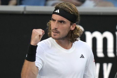 Stefanos Tsitsipas of Greece reacts after winning a point against Quentin Halys of France during their first round match at the Australian Open tennis championship in Melbourne, Australia, Monday, Jan. 16, 2023. (AP Photo/Dita Alangkara)
