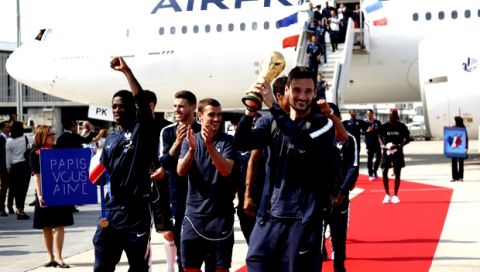 French goalkeeper Hugo Lloris holds the cup as the French soccer team arrives at Charles de Gaulle airport, Monday, July 16, 2018 in Roissy, north of Paris. France is preparing to welcome home the national soccer team for a victory lap down the grand Champs-Elysees avenue, where hundreds of thousands thronged after the team's 4-2 victory Sunday over Croatia to capture the trophy. (AP Photo/Bob Edme)