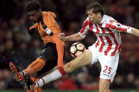 Stoke City's Peter Crouch, right, and Wolverhampton Wanderers' Bright Enobakhare battle for the ball during the English FA Cup, third round soccer match at the Bet365 Stadium, Stoke, England, Saturday Jan. 7, 2017. (Mike Egerton/PA via AP)