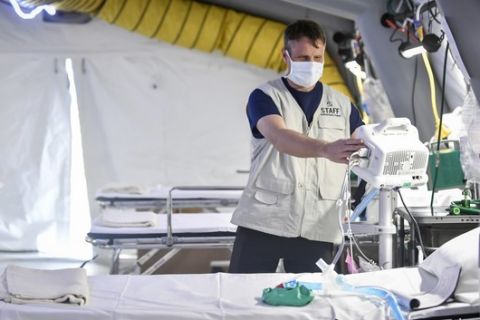 A staffer checks equipment in the ICU room at the Samaritans Purse field hospital that is being set up in Cremona, northern Italy, Friday, March 20, 2020. A Christian evangelical group headed by the son of the late televangelist Billy Graham has sent a field hospital to northern Italy to tend to coronavirus patients, joining China in offering aid to Italys overwhelmed health care system. For most people, the new coronavirus causes only mild or moderate symptoms. For some it can cause more severe illness. (Claudio Furlan/LaPresse via AP)
