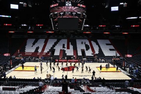 A general view shirts on the seats honoring Miami Heat's Dwyane Wade (3) prior to his final regular season home game of his career at American Airlines Arena prior to the game between the Philadelphia 76ers before an NBA basketball game Tuesday, April 9, 2019, in Miami. (AP Photo/Brynn Anderson)
