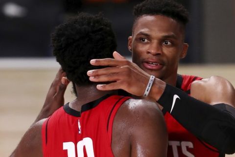 Houston Rockets Russell Westbrook, right, celebrates with James Harden (13) after defeating the Dallas Mavericks in an NBA basketball game Friday, July 31, 2020, in Lake Buena Vista, Fla. (Mike Ehrmann/Pool Photo via AP)