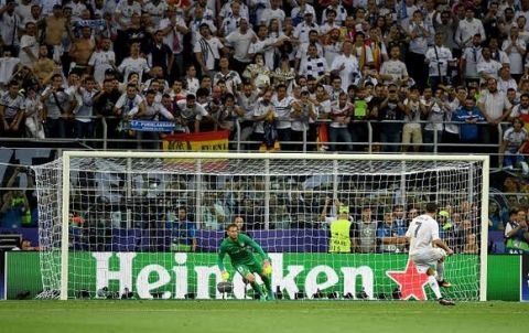 MILAN, ITALY - MAY 28: Cristiano Ronaldo of Real Madrid scores the winning  penalty  during the UEFA Champions League Final match between Real Madrid and Club Atletico de Madrid at Stadio Giuseppe Meazza on May 28, 2016 in Milan, Italy.  (Photo by Shaun Botterill/Getty Images)