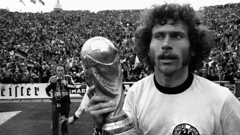 West German defender Paul Breitner, holds the World Cup aloft while running around the Olympic stadium after West Germany beat Holland 2-1 in the Football World Cup Final game in Munich, Germany on July 7, 1974. (AP Photo)