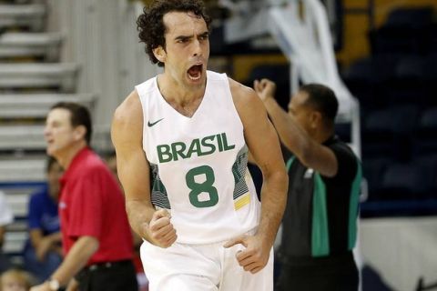 Brazil's Vitor Benite reacts after sinking a 3-point shot during the first quarter of a men's basketball game against Puerto Rico at the Pan Am Games, Tuesday, July 21, 2015, in Toronto. (AP Photo/Julio Cortez)