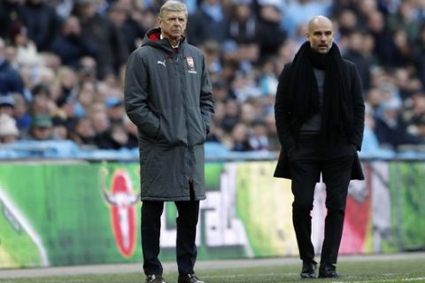 Arsenal manager Arsene Wenger, left, and Manchester City coach Pep Guardiola stand next to each other during the English League Cup final soccer match between Arsenal and Manchester City at Wembley stadium in London, Sunday, Feb. 25, 2018. (AP Photo/Frank Augstein)
