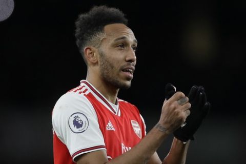 Arsenal's Pierre-Emerick Aubameyang celebrates with fans at the end of the English Premier League soccer match between Arsenal and Everton at Emirates stadium in London, Sunday, Feb. 23, 2020. Arsenal won 3-2. (AP Photo/Kirsty Wigglesworth)