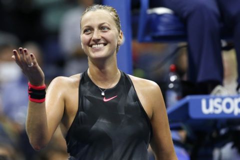 Petra Kvitova, of the Czech Republic, gestures toward her coaches and family box after defeating Garbine Muguruza, of Spain, 7-6 (3), 6-3, in a fourth round match at the U.S. Open tennis tournament in New York, Sunday, Sept. 3, 2017. (AP Photo/Kathy Willens)