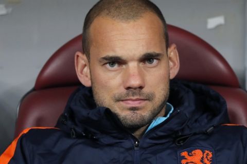 FILE - In this Tuesday Nov. 14, 2017 file photo Netherlands' Wesley Sneijder looks out from the bench prior to the start of a during the international friendly soccer match between Netherlands and Romania on the National Arena stadium in Bucharest, Romania. Midfielder Wesley Sneijder is retiring from international football after 15 years and a record 133 appearances for the Netherlands. The Dutch football association announced the retirement Sunday after new coach Ronald Koeman visited 33-year-old Sneijder in Qatar, where he plays for Al Gharafa. (AP Photo/Vadim Ghirda)