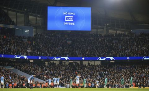 A big screen shows Manchester City's Raheem Sterling's goal was disallowed for offside against Manchester City's Sergio Aguero following a VAR review during the Champions League quarterfinal, second leg, soccer match between Manchester City and Tottenham Hotspur at the Etihad Stadium in Manchester, England, Wednesday, April 17, 2019. (AP Photo/Jon Super)
