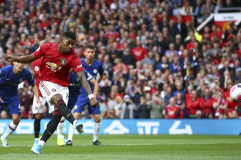 Manchester United's Marcus Rashford shoots a penalty kick to score his sides first goal during the English Premier League soccer match between Manchester United and Chelsea at Old Trafford in Manchester, England, Sunday, Aug. 11, 2019. (AP Photo/Dave Thompson)