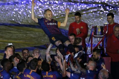 FC Barcelona's Andres Iniesta is tossed by his teammates after the Spanish La Liga soccer match between FC Barcelona and Real Sociedad at the Camp Nou stadium in Barcelona, Spain, Sunday, May 20, 2018. Iniesta announced last month he would leave Barcelona after 16 seasons. (AP Photo/Manu Fernandez)