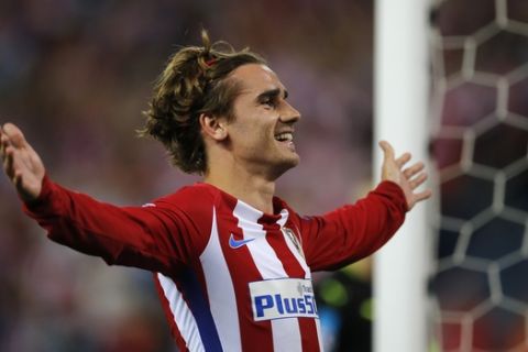 FILE - In this Wednesday, April 12, 2017 file photo, Atletico's Antoine Griezmann celebrates after scoring from the penalty spot the opening goal of the game during the Champions League quarterfinal first leg soccer match between Atletico Madrid and Leicester City at the Vicente Calderon stadium in Madrid, Spain. (AP Photo/Paul White, File)