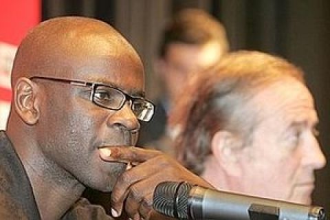 Former France defender Lilian Thuram, left, pauses during a press conference while Paris Saint Germain President Charles Villeneuve sits next to him at Parc  des Prince Stadium in Paris, Friday, June 27, 2008. Thuram has a heart problem that will delay a move to Paris Saint-Germain and could end his career. (AP Photo/Michel Euler0