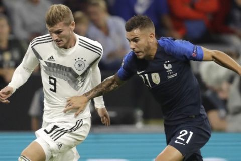 Germany's Timo Werner, left, and France's Lucas Hernandez challenge for the ball during the UEFA Nations League soccer match between Germany and France in Munich, Germany, Thursday, Sept. 6, 2018. (AP Photo/Michael Probst)